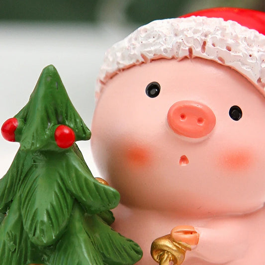 Pig figurine with Santa hat and Christmas tree, close-up