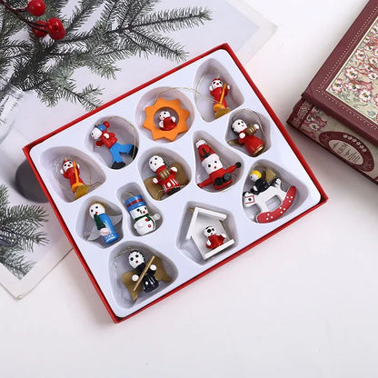 Set of Christmas-themed figurines in a decorative box with holiday decorations around.