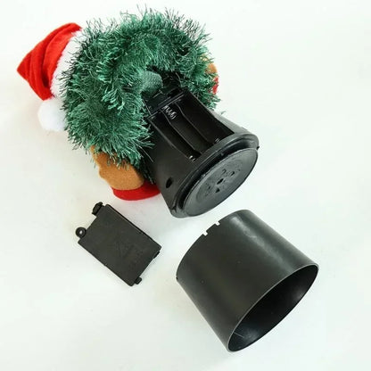 Black mechanical component with a small green tree and Santa hat on a white background