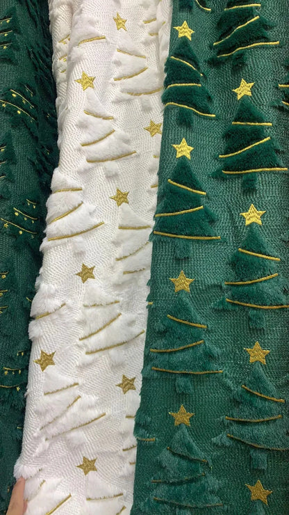 Two fabric swatches with embroidered patterns of trees and stars.
