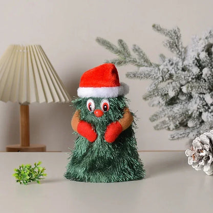 Green plush toy with a Santa hat, red gloves, and white trim on a neutral background.