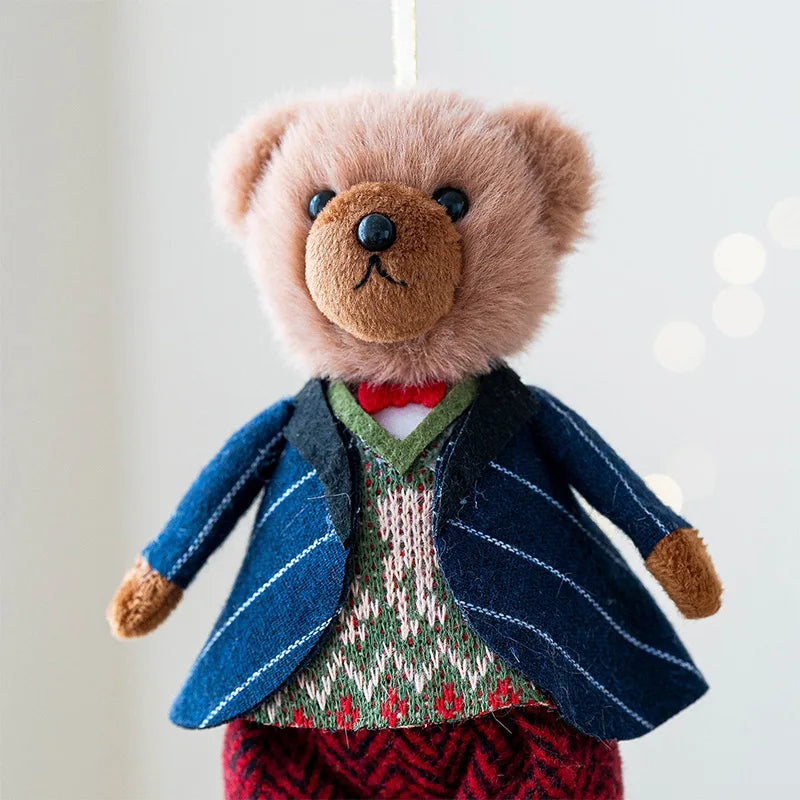 Teddy bear wearing a blue suit and red bow tie against a white background
