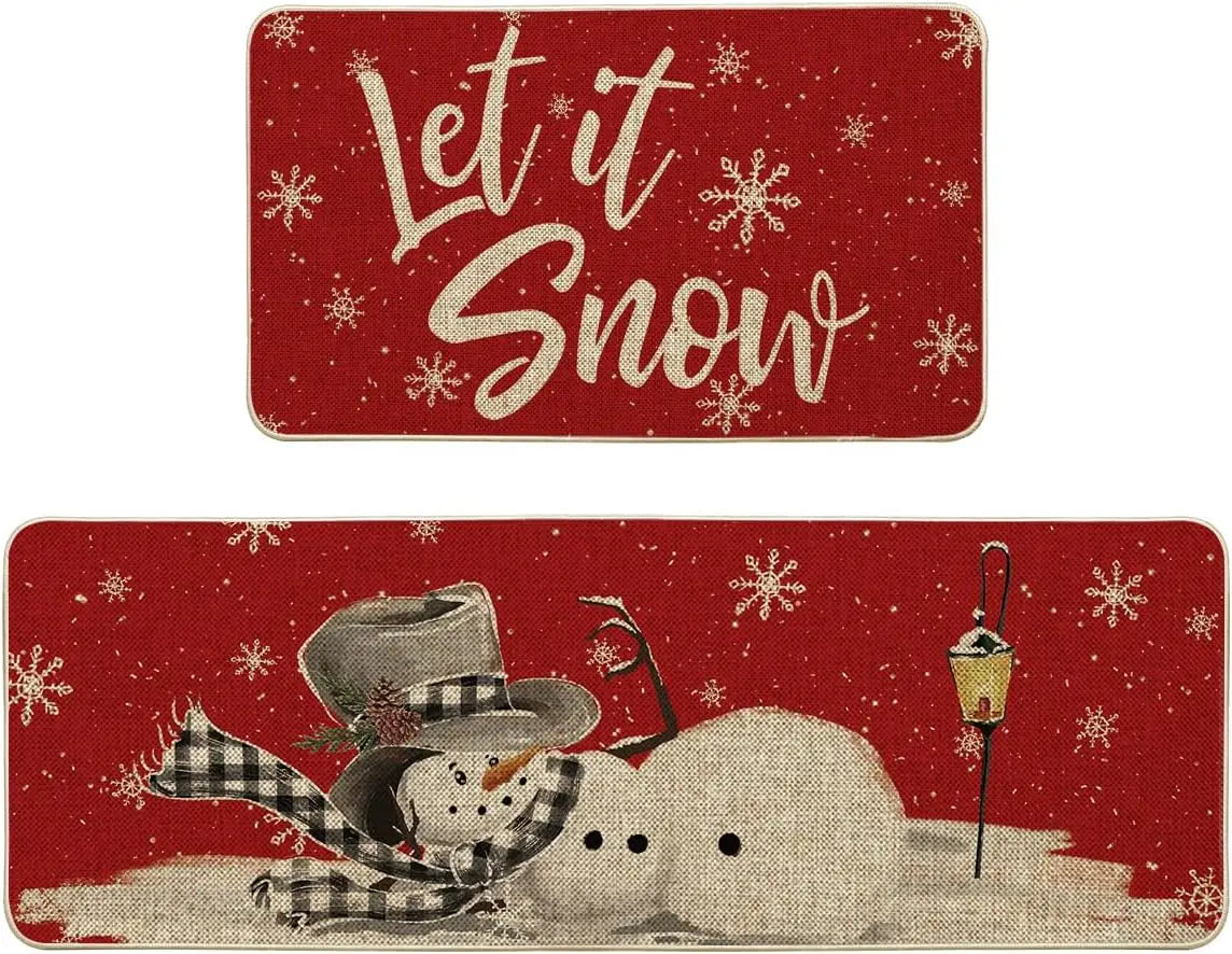 Two Christmas-themed placemats with a snowman and 'Let it Snow' text on a red background.