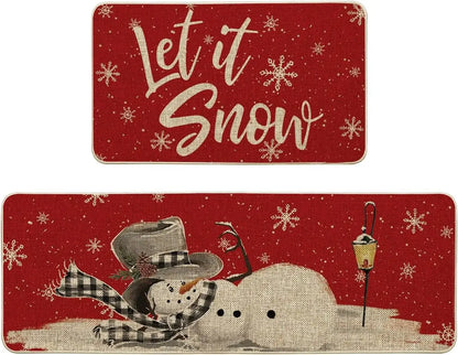 Two Christmas-themed placemats with a snowman and 'Let it Snow' text on a red background.