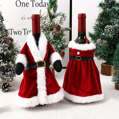 Two wine bottles in Santa Claus costumes on a textured surface with Christmas trees in the background.