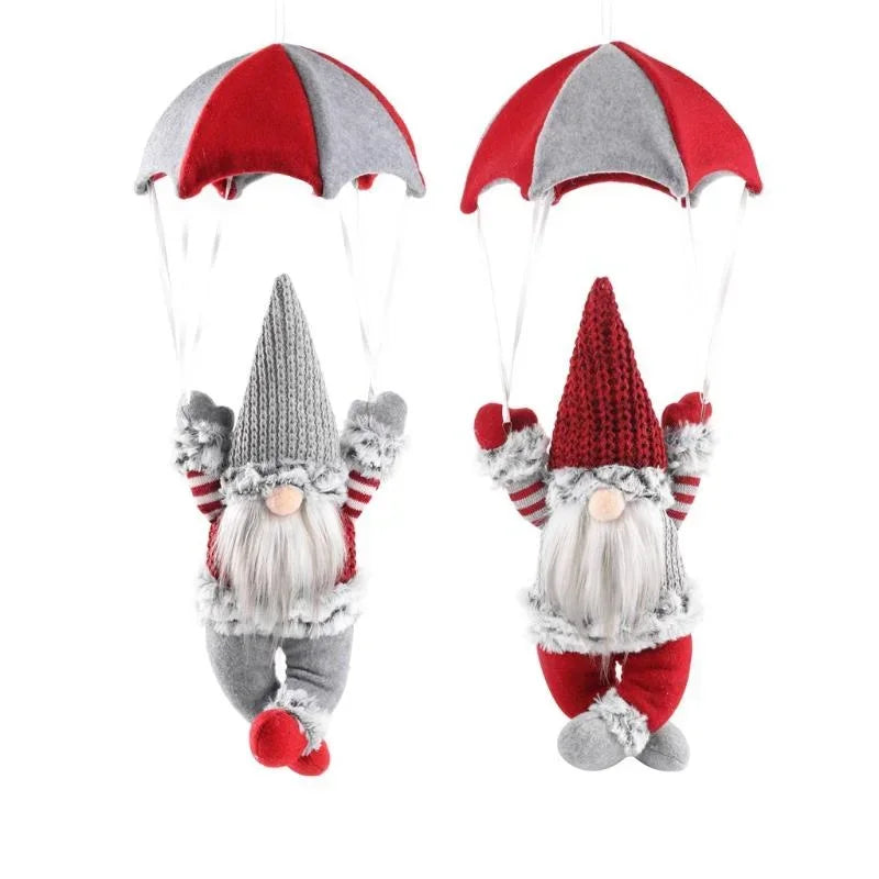 Two knitted gnomes with red and gray hats on a white background