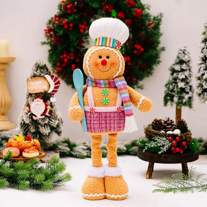 Decorative gingerbread man toy with a colorful scarf and apron, surrounded by Christmas decorations.