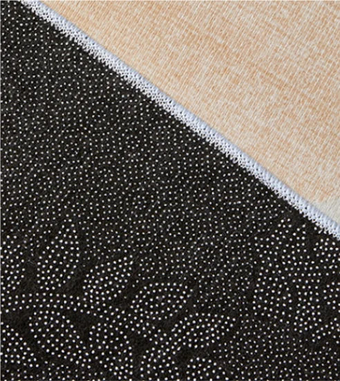 Close-up of black textured fabric with white dots on a beige fabric background