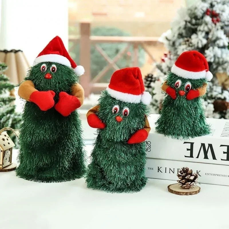 Three green Christmas-themed figures with red hats and scarves on a decorative surface.