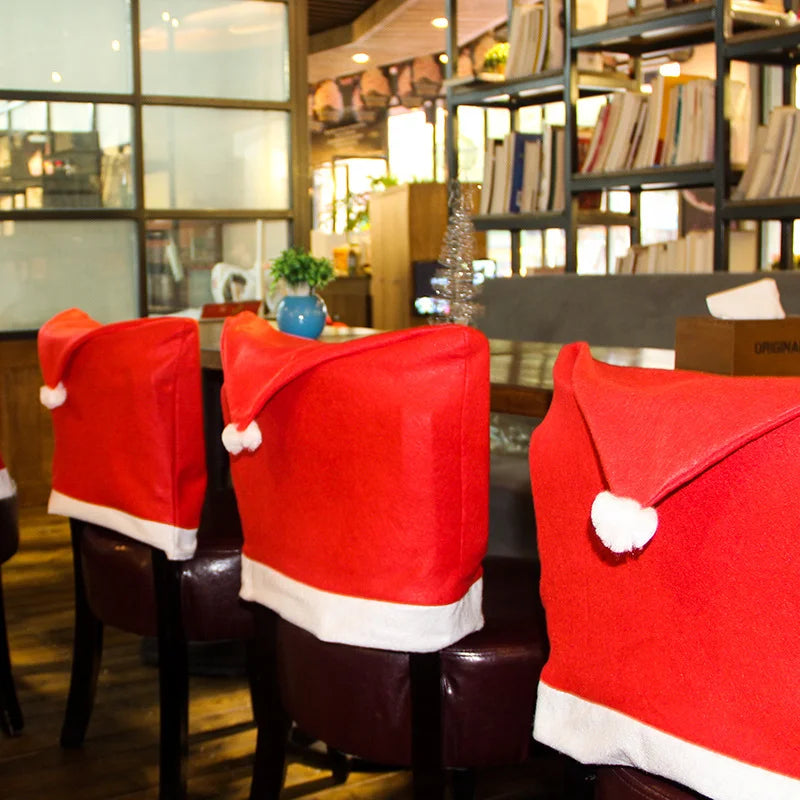 Red Santa hat covers on chairs in a restaurant setting