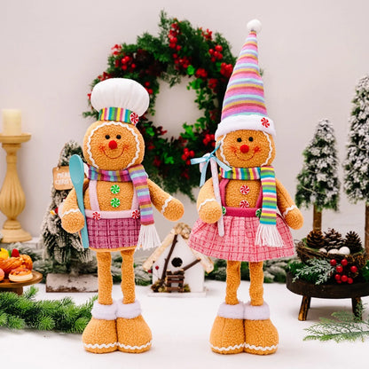 Two gingerbread-themed dolls with colorful hats and scarves in a festive setting.