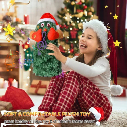 Child holding a plush toy with a Christmas tree design in front of a decorated Christmas tree.