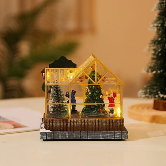 Decorative miniature house with Christmas trees and figures on a blurred background