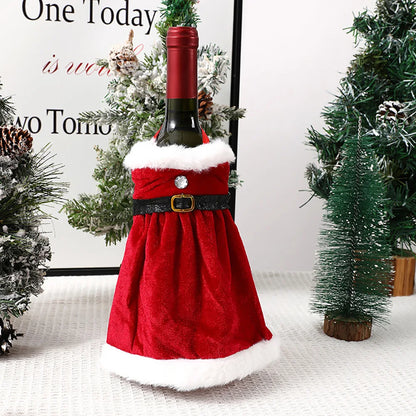 Red wine bottle in a Santa Claus costume with Christmas trees in the background