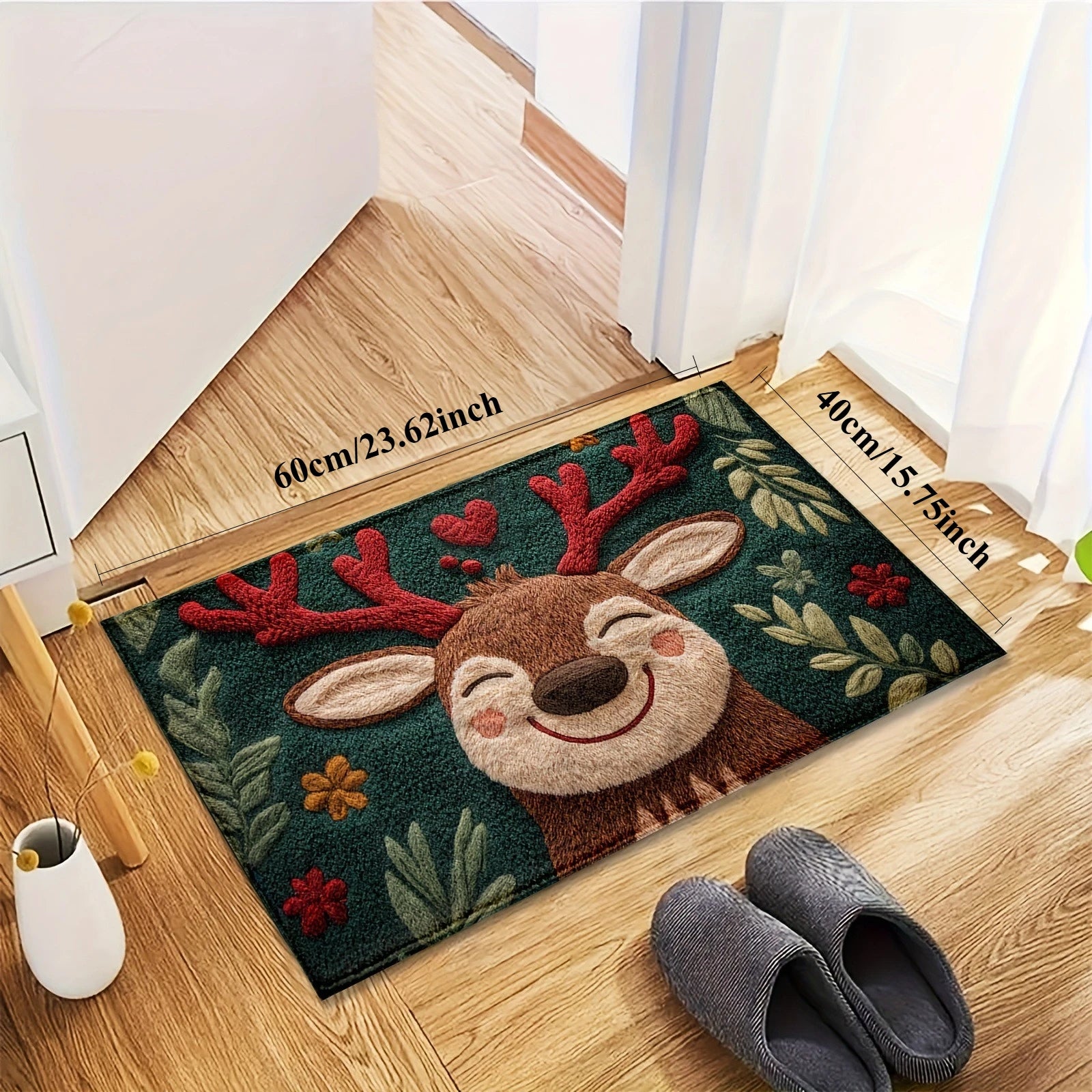 Doormat with a reindeer design on a wooden floor next to a white vase and gray slippers.