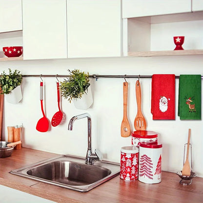 Kitchen with Christmas-themed decor including red and white mugs, utensils, and towels.