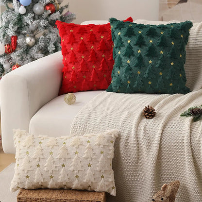 Decorative pillows on a couch with a Christmas tree in the background