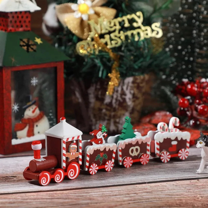 Christmas-themed toy train set with Santa Claus and gingerbread men on a wooden surface.