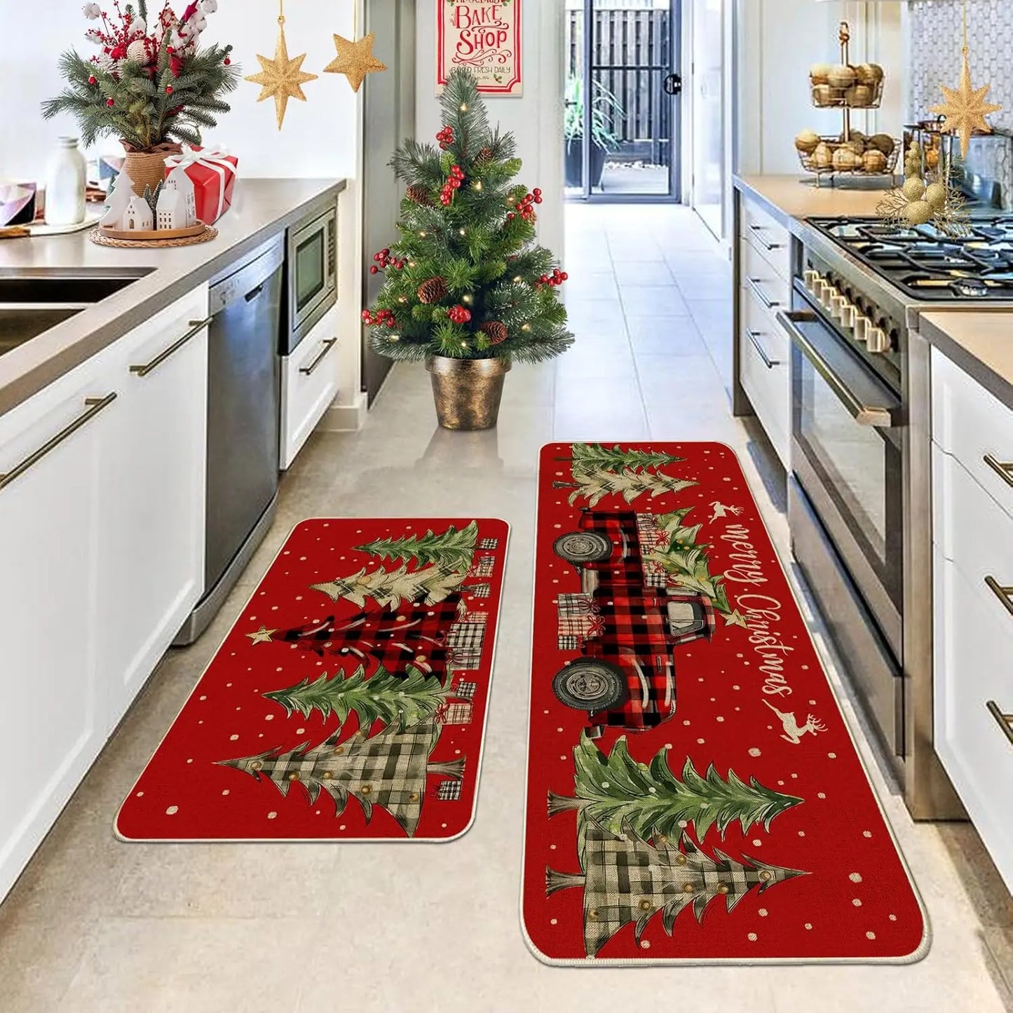 Two Christmas-themed kitchen mats on a floor with a decorated kitchen in the background.