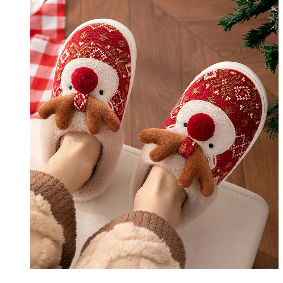 Red and white Christmas-themed slippers with reindeer faces worn by a person.