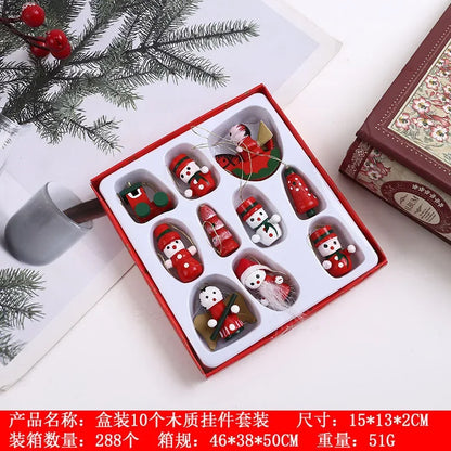 Set of Christmas-themed wooden ornaments in a box with decorative elements on a white surface.