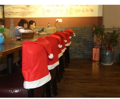 Row of chairs with Santa hats in a restaurant setting