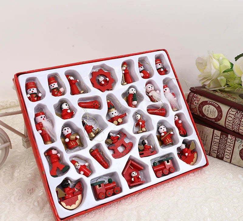 Set of red Christmas-themed figurines in a box on a light surface.