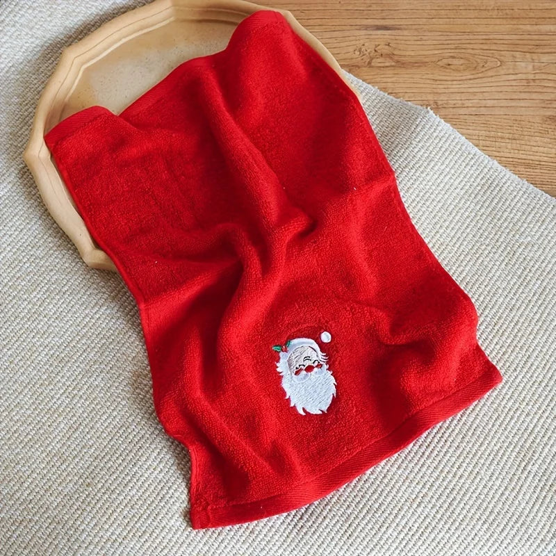 Red towel with a Santa Claus embroidery on a textured surface